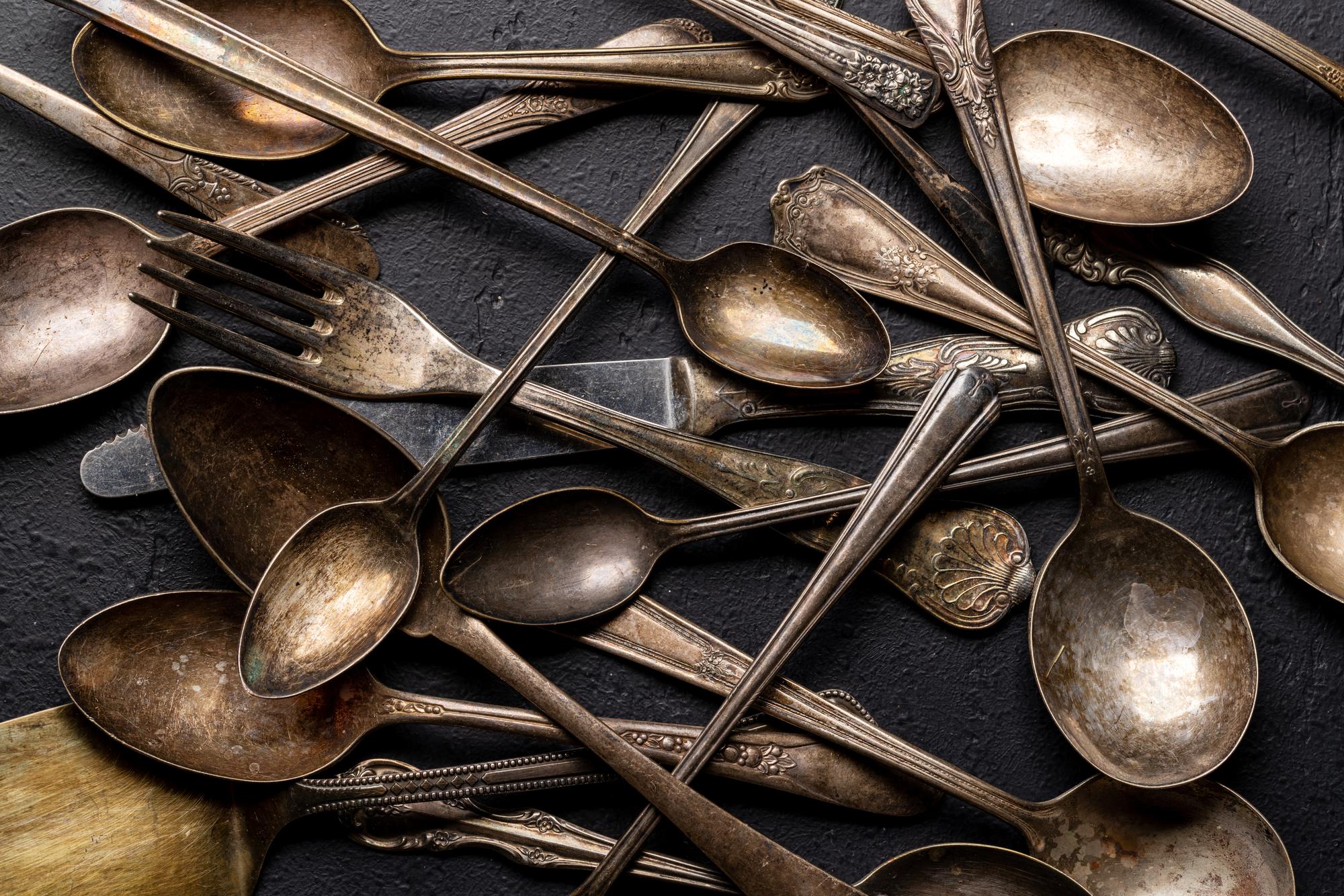 Copper pans and wooden spoons on marble